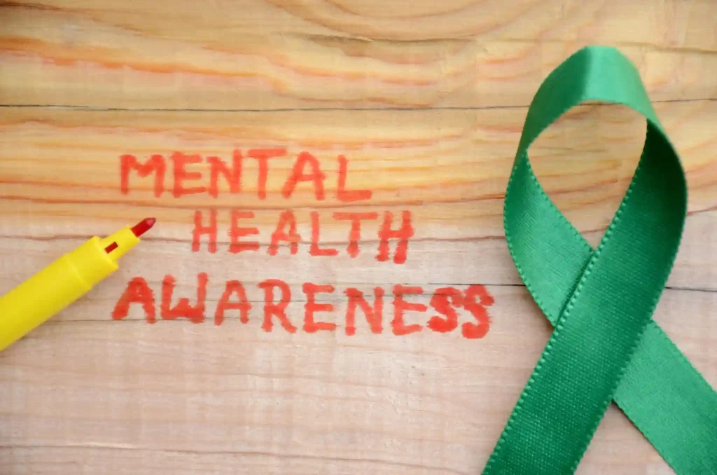 What role do schools and workplaces play in mental health awareness?